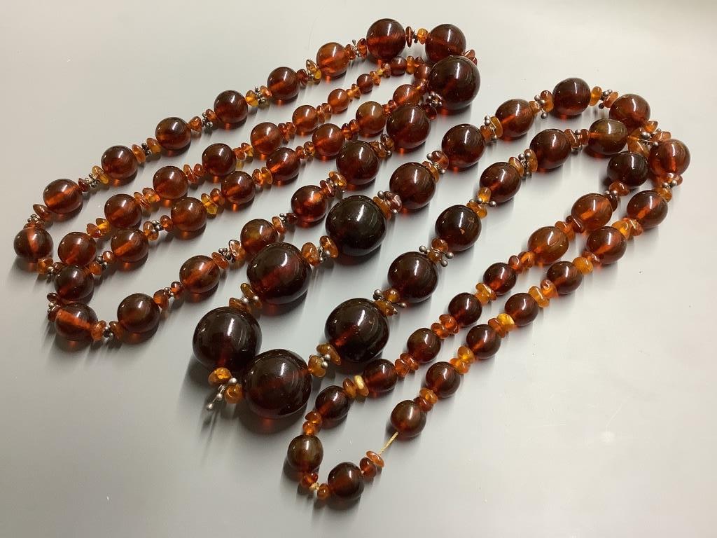Two single strand reconstituted and natural amber necklaces, both approximately 80 cm, gross weight 172 grams.